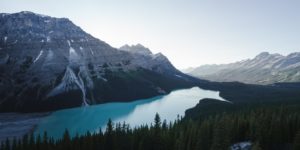 snow-capped-mountain-next-to-lake-under-blue-sky-2356064